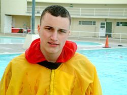 pool lifeguard swimming in uniform clothes